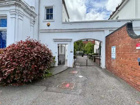The gated access to the right hand side leads to a shared car park. 