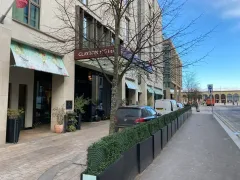 Clayton Hotel Cambridge exterior on Station Road, glass-and-steel modern building with smooth wide pavements and corporate office buildings opposite