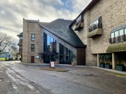 Front angled view of The Graduate Hotel showing the drop off area. Driving past this view will have you finding the car park on the right.