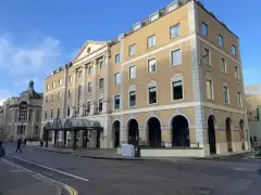 Hilton Cambridge City Centre entrance on Downing Street with the Sedgewick Museum of Earth Sciences visible opposite