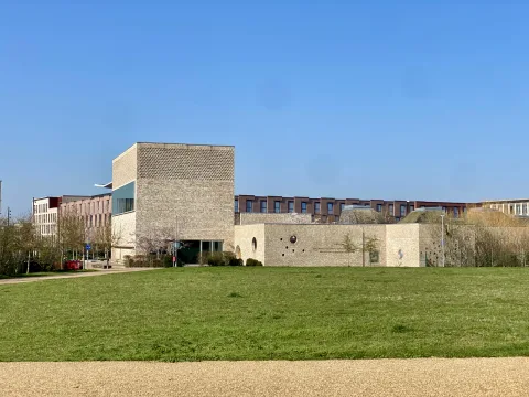Hotel seen in the distance from the green space very close by.