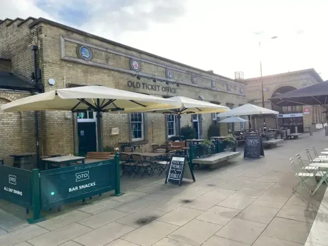 The Old Ticket Office (OTO) pub which leans into the vibe of the original station terminal. It is right next to the food vendors in another image here. 