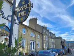 Lensfield Hotel entrance on a bright afternoon, Cambridge, showing the subtle frontage on a busy single-lane road with residential buildings opposite