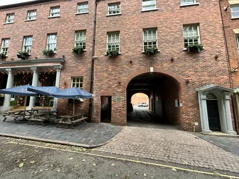 The car park is accessed through the archway to the right of the hotel.
