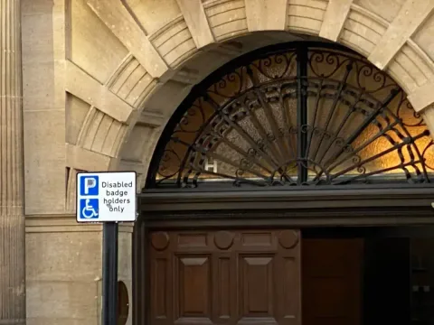 View of part of the main entrance with the disabled parking sign. 