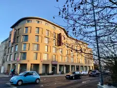 Premier Inn Cambridge City East entrance on Coldham's Lane with dedicated taxi pull-in bay and Newmarket Road junction visible in background