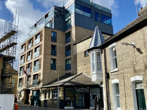 Seeing the varsity with the street to Jesus Green behind the photographer. The hotel entrance can be seen below the Union Jack.