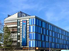Travelodge Cambridge Central hotel entrance facing the Cambridge Leisure Park, with the Cambridge Junction venue visible to the left